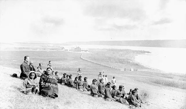 Students and staff of the Fort Qu'Appelle Industrial School on a hillside overlooking the valley